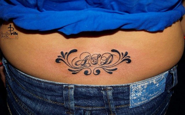Fleur-tatouage sur le bas du dos taille